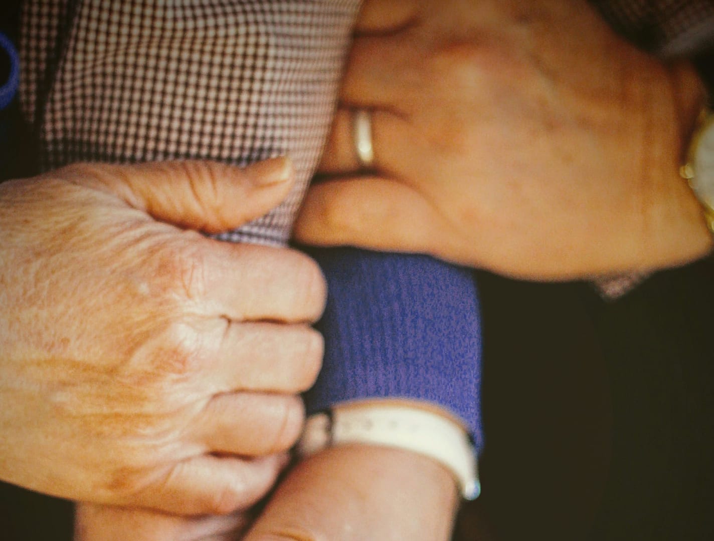 A close-up photo of hands providing support.